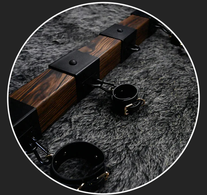 Elm wood spreader bar side view with zoom detail of carbonized texture and steel cuff - BDSM Authority