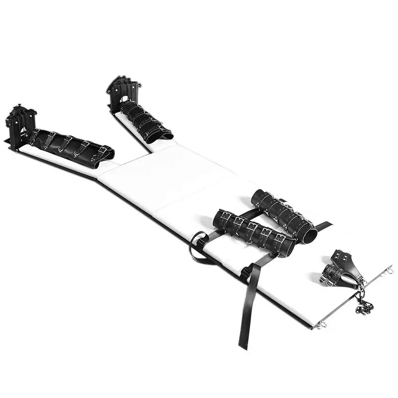 Heavy-duty bondage bed with padded restraint cuffs and adjustable spread positioning