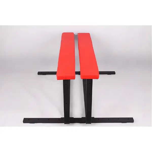 Red cushion spanking bench close front view highlighting padded surface and reinforced frame design