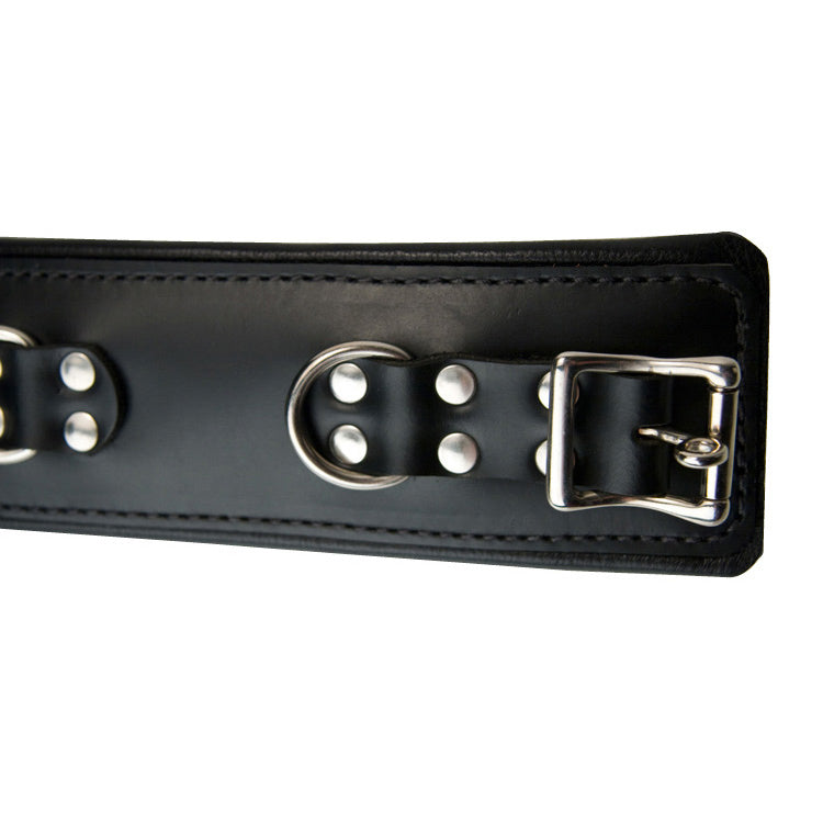 Close detail of the triple-layer padded leather ankle cuff - BDSM Authority