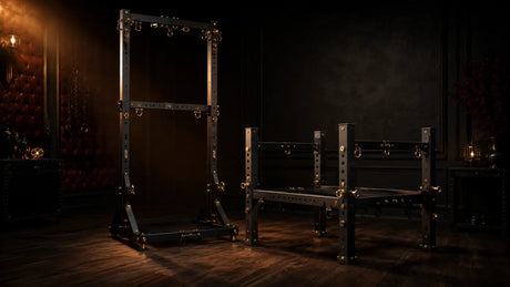 Premium freestanding steel bondage racks and frames in a dark editorial dungeon, BDSMAuthority