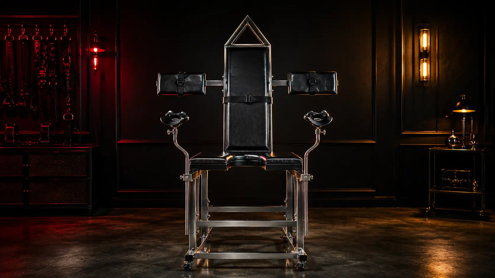 Empty stainless steel gyno chair in moody clinical room BDSMAuthority