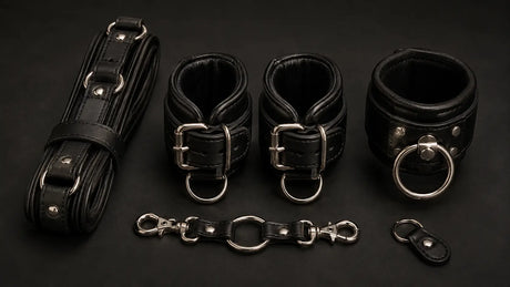 Premium leather cuffs and restraints flat lay BDSMAuthority