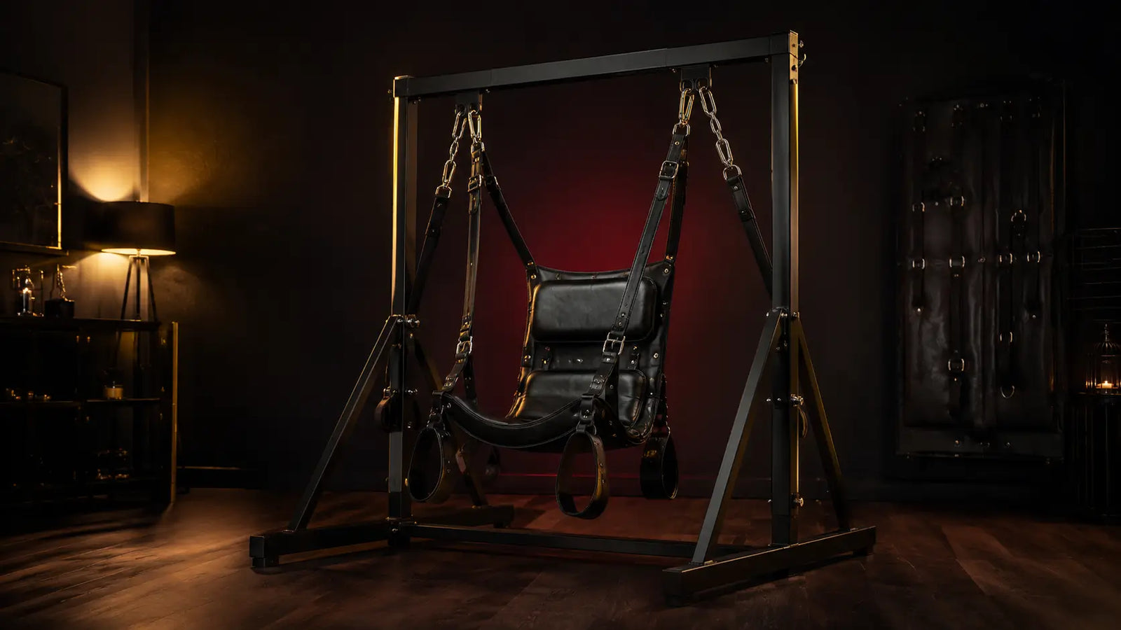 Leather sex sling on a steel stand in a dark editorial dungeon setting BDSMAuthority