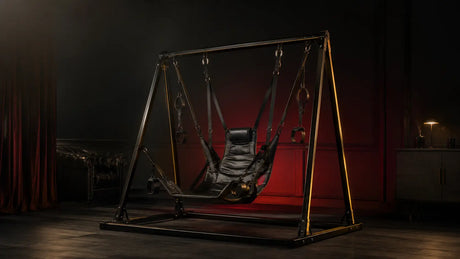 Leather sex sling and steel swing stand in a dark editorial setting BDSMAuthority
