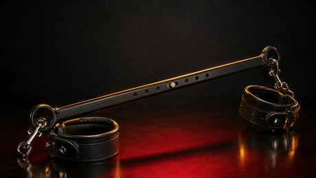 Premium adjustable spreader bar with leather cuffs on dark studio background BDSMAuthority