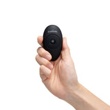 The Cowgirl Saddle Machine wireless remote held in hand - BDSM Authority