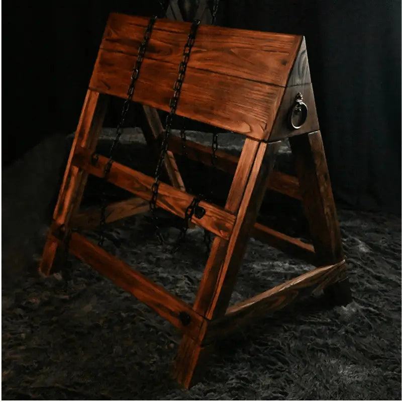 Adjustable kneeling and prone triangular wooden horse HQSM-018 side view with chain featuring durable wooden frame, ergonomic angled support, and adjustable restraint system for specialized training or therapy use
