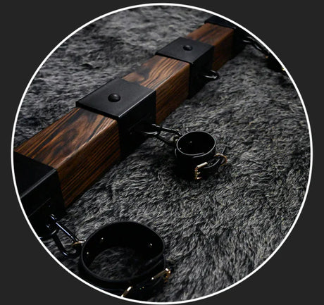 Elm wood spreader bar side view with zoom detail of carbonized texture and steel cuff - BDSM Authority