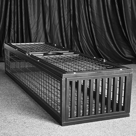 Heavy-duty standing BDSM cage front view showing welded steel bars and lockable door, BDSM Authority