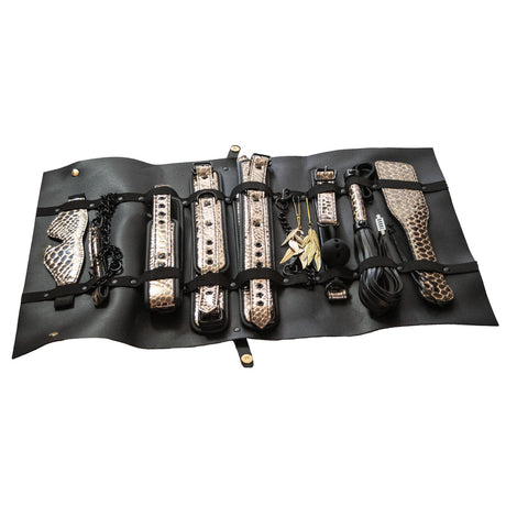 The Traveler bondage kit cuffs collar nipple clamps ball gag laid out at BDSM Authority