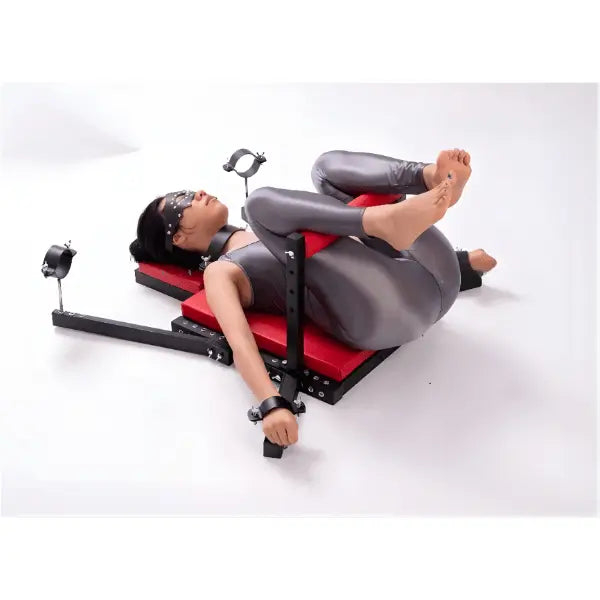 Portable commercial-grade adjustable restraint bench system, side view showing full structure and ergonomic platform design