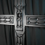 Close-up view of a premium black St. Andrew’s cross featuring padded leather-style panels, reinforced steel frame, restraint chains, and central restraint ring. Luxury BDSM furniture detail designed for upscale dungeon interiors, private playrooms, and commercial studio environments.
