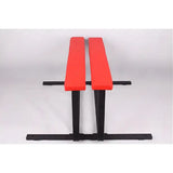 Red cushion spanking bench close front view highlighting padded surface and reinforced frame design
