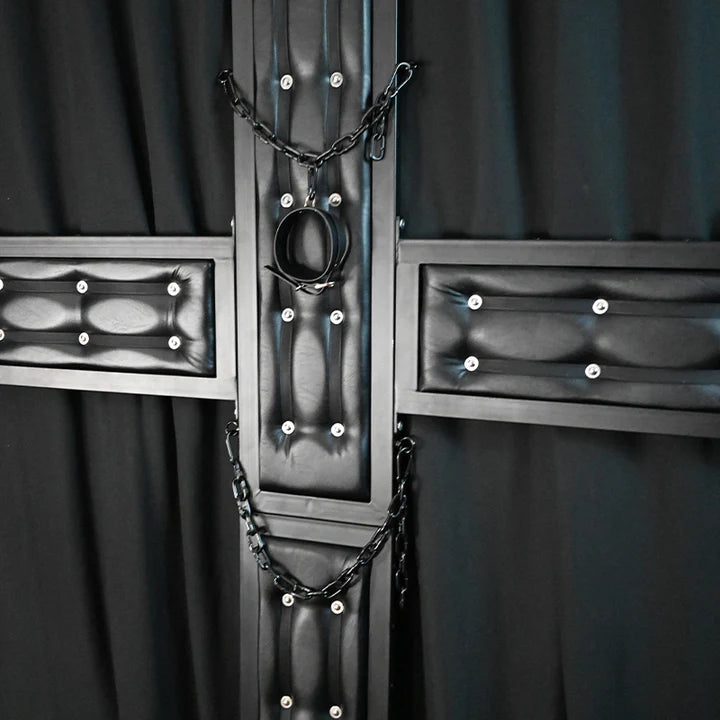 St. Andrew’s Cross Wall-Mounted Cruciform Restraint System with neck shackles, sturdy wall-mounted frame, angled support design, and multiple restraint points.
