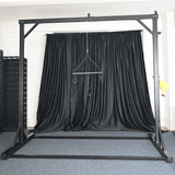 Studio gantry rack side view with reinforced steel uprights and adjustable suspension points, BDSM Authority