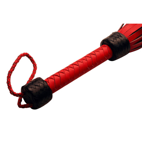 Close up detail of the leather wrapped handle and braided wrist loop - BDSM Authority