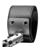 Close up of a single padded leather cuff with squared locking ring on the spreader bar - BDSM Authority