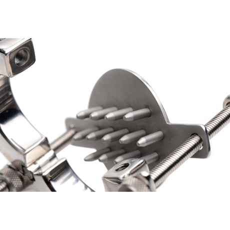 Close-up of the ball stretcher rings and the raised plate of sharp spike points - BDSM Authority