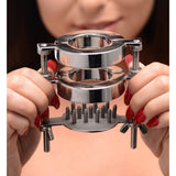 Steel dual-ring ball stretcher held in hands to show its scale - BDSM Authority