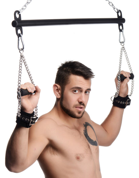 Levitate suspension bar suspending a model's arms overhead - BDSM Authority